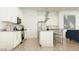 Modern kitchen with stainless steel appliances, white cabinets, and a center island with bar seating at 17539 W Victory St, Goodyear, AZ 85338