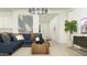 Cozy living room with a comfortable blue sofa, stylish decor, and plenty of natural light at 17539 W Victory St, Goodyear, AZ 85338