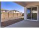 Covered patio with view of low maintenance backyard with gravel and block wall at 17545 W Victory St, Goodyear, AZ 85338