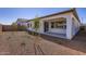 View of the backyard from the side featuring gravel and trees/bushes at 17545 W Victory St, Goodyear, AZ 85338