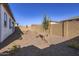 Low maintenance backyard features gravel and small trees/bushes at 17545 W Victory St, Goodyear, AZ 85338