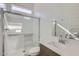 Bathroom featuring white subway tile shower, glass door and vanity at 17545 W Victory St, Goodyear, AZ 85338