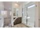 A bathroom features a tiled floor, glass shower, and a vanity with cabinets and drawers at 17545 W Victory St, Goodyear, AZ 85338