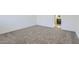 An empty bedroom features carpeted floors and white walls with an ensuite bathroom at 17545 W Victory St, Goodyear, AZ 85338