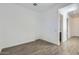 An empty bedroom features a tiled floor and white walls with an ensuite bathroom at 17545 W Victory St, Goodyear, AZ 85338