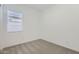 Bright bedroom features neutral carpet and natural light from a window at 17545 W Victory St, Goodyear, AZ 85338
