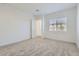 An empty bedroom features carpeted floors, white walls, and a window with blinds at 17545 W Victory St, Goodyear, AZ 85338