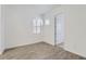 An empty bedroom features a tiled floor, white walls, and two windows with blinds at 17545 W Victory St, Goodyear, AZ 85338