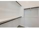 A closet features two levels of wooden rails attached to shelves, and carpet flooring at 17545 W Victory St, Goodyear, AZ 85338