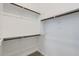 A closet features two levels of wooden rails attached to shelves, and carpet flooring at 17545 W Victory St, Goodyear, AZ 85338