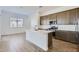 Spacious kitchen featuring a center island, stainless steel appliances, and plenty of natural light from a nearby window at 17545 W Victory St, Goodyear, AZ 85338