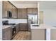 Well-equipped kitchen featuring stainless steel appliances, modern cabinetry, and a functional center island at 17545 W Victory St, Goodyear, AZ 85338