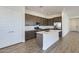 Bright, open kitchen with a large island, modern appliances, and stylish cabinetry, perfect for cooking and entertaining at 17545 W Victory St, Goodyear, AZ 85338