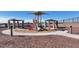 Community playground featuring a slide, climbing structures, and picnic tables at 17545 W Victory St, Goodyear, AZ 85338
