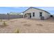 Backyard with rock landscaping, trees and covered patio at 17806 W Vogel Ave, Waddell, AZ 85355