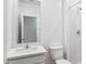Bright white bathroom featuring white marble shower surround and corner vanity at 17806 W Vogel Ave, Waddell, AZ 85355