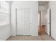 A bedroom with neutral carpet and a door leading to the walk-in closet at 17806 W Vogel Ave, Waddell, AZ 85355