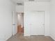 A bright bedroom with neutral carpet and a view of other rooms at 17806 W Vogel Ave, Waddell, AZ 85355