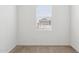 A sunlit bedroom with neutral carpet and neighborhood view at 17806 W Vogel Ave, Waddell, AZ 85355