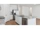 Modern kitchen boasts white cabinets, granite countertops, stainless steel appliances and a large island at 17806 W Vogel Ave, Waddell, AZ 85355
