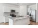 Modern kitchen boasts white cabinets, granite countertops, stainless steel appliances and a large island at 17806 W Vogel Ave, Waddell, AZ 85355