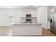 Modern kitchen boasts white cabinets, granite countertops, stainless steel appliances and a large island at 17806 W Vogel Ave, Waddell, AZ 85355