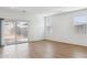 Bright living room featuring tile flooring and a sliding glass door leading to the backyard at 17806 W Vogel Ave, Waddell, AZ 85355