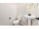 A half bathroom features a pedestal sink with black hardware and a circular mirror at 18759 E Panchito Dr, Gold Canyon, AZ 85118