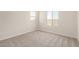 This bedroom features neutral carpet, and two windows for natural light at 18759 E Panchito Dr, Gold Canyon, AZ 85118