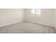 Neutral bedroom features plush carpet, white walls, and a window for natural light at 18759 E Panchito Dr, Gold Canyon, AZ 85118