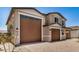 View of the facade with two brown garage doors and neat landscaping at 18759 E Panchito Dr, Gold Canyon, AZ 85118