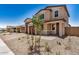 Beautiful home featuring desert landscaping, brown garage door and covered entrance at 18759 E Panchito Dr, Gold Canyon, AZ 85118
