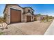 Charming two-story home with brown garage doors and brick-paved driveway at 18759 E Panchito Dr, Gold Canyon, AZ 85118