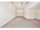 Spacious garage featuring concrete floors, white walls, and several windows at 18759 E Panchito Dr, Gold Canyon, AZ 85118