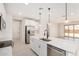 Modern kitchen with white cabinets, stainless appliances, island and pendant lights at 18759 E Panchito Dr, Gold Canyon, AZ 85118