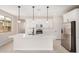Bright modern kitchen featuring white cabinets, stainless appliances, and an island at 18759 E Panchito Dr, Gold Canyon, AZ 85118