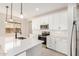 Modern kitchen featuring white cabinets, stainless appliances, and a large island at 18759 E Panchito Dr, Gold Canyon, AZ 85118