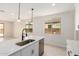 Bright modern kitchen with white cabinets, stainless sink, and pendant lights at 18759 E Panchito Dr, Gold Canyon, AZ 85118