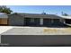 Charming single-story home featuring a gray exterior, low-maintenance yard, and covered front porch at 1915 W Missouri Ave, Phoenix, AZ 85015
