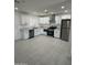 Bright modern kitchen with stainless steel appliances, white cabinets, and tile floors at 1915 W Missouri Ave, Phoenix, AZ 85015