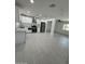 Bright kitchen features stainless steel appliances, white cabinets, light countertops and tile flooring at 1915 W Missouri Ave, Phoenix, AZ 85015