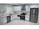 Modern kitchen featuring white cabinets, stainless steel appliances, and light countertops at 1915 W Missouri Ave, Phoenix, AZ 85015