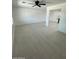 Open-concept living area featuring modern tile flooring, ceiling fan, and access to the kitchen at 1915 W Missouri Ave, Phoenix, AZ 85015