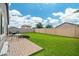 Spacious backyard with artificial grass, covered patio, BBQ, table and chairs, and a walled perimeter at 19585 W Washington St, Buckeye, AZ 85326