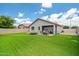 Spacious backyard with synthetic grass, covered patio, lounge chairs, and a privacy fence, perfect for outdoor living at 19585 W Washington St, Buckeye, AZ 85326