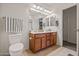 This bathroom has a double sink vanity, large mirror with lighting, and tile flooring at 19585 W Washington St, Buckeye, AZ 85326
