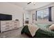 Bright bedroom featuring a large window, and neutral color palette, and view to additional rooms at 19585 W Washington St, Buckeye, AZ 85326
