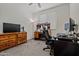 Bedroom with a modern desk, large dresser, comfortable chair, and plenty of natural light from the window at 19585 W Washington St, Buckeye, AZ 85326