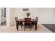 Cozy dining room featuring a wooden table and seating arrangement with an elegant decorative floral arrangement at 19585 W Washington St, Buckeye, AZ 85326