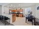 Open kitchen with wooden cabinets, stainless steel appliances, a breakfast bar, and an adjacent dining area at 19585 W Washington St, Buckeye, AZ 85326